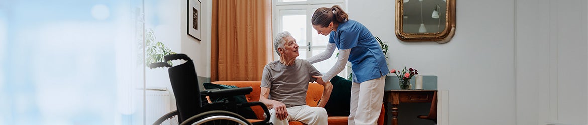 Stock image: Medical staff helping a person in a wheelchair