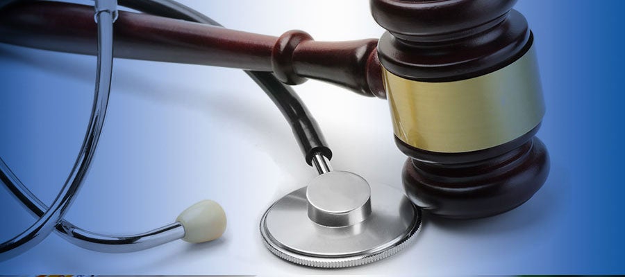 stethoscope and gavel on white surface