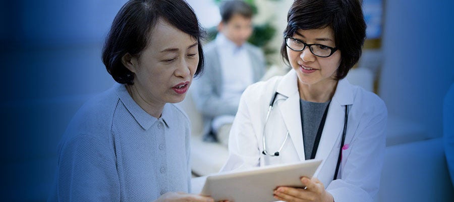 A clinician and patient looking at tablet