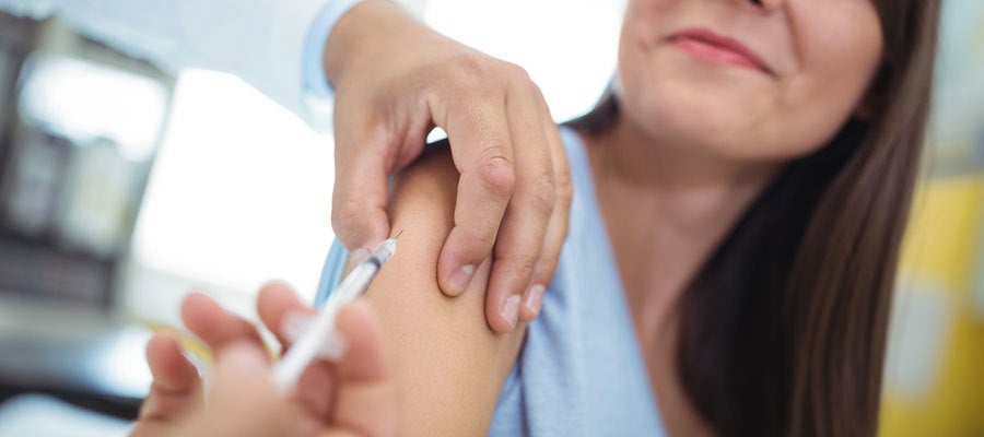 woman receives flu shot