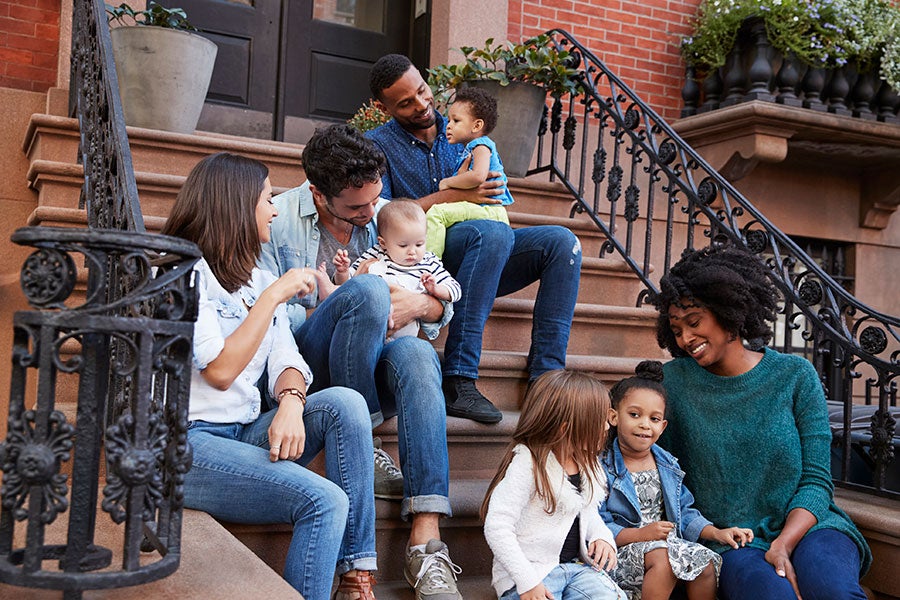 family on stoop in city