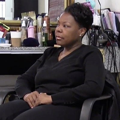 palliative care patient Debbie sitting in chair in her salon