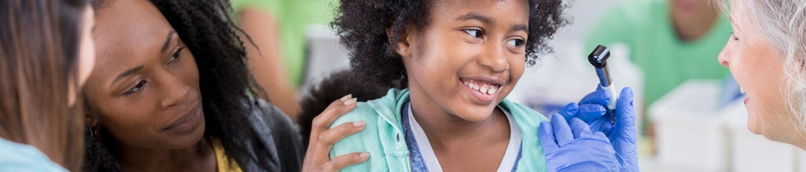 girl getting examined at free clinic health fair