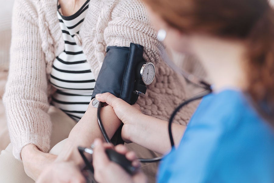 nurse taking patient blood pressure