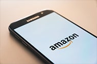 Amazon Takes First Step into Virtual Primary Care. A mobile phone with the Amazon logo showing on the screen.