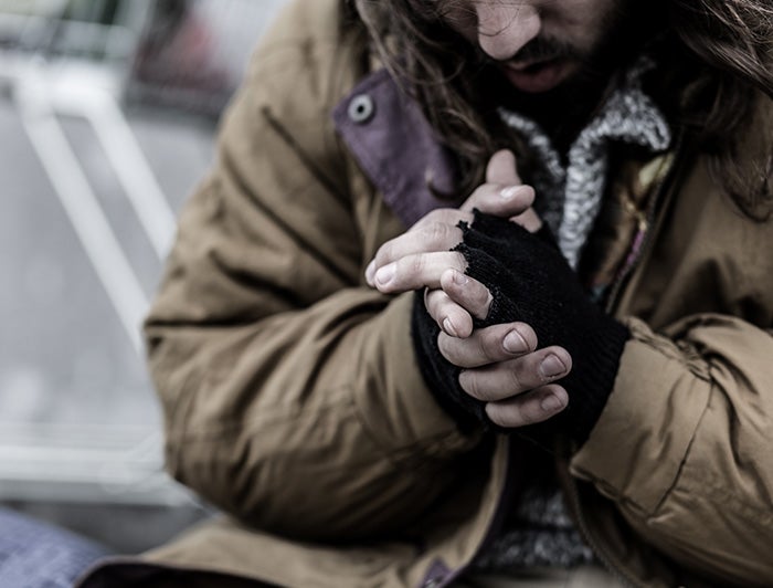 Person in jacket trying to keep hands warm