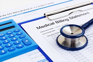 Coronavirus COVID-19 Coverage Reimbursement stock. A calculator, a medical billing statement, a health insurance claim form, and a stethoscope.