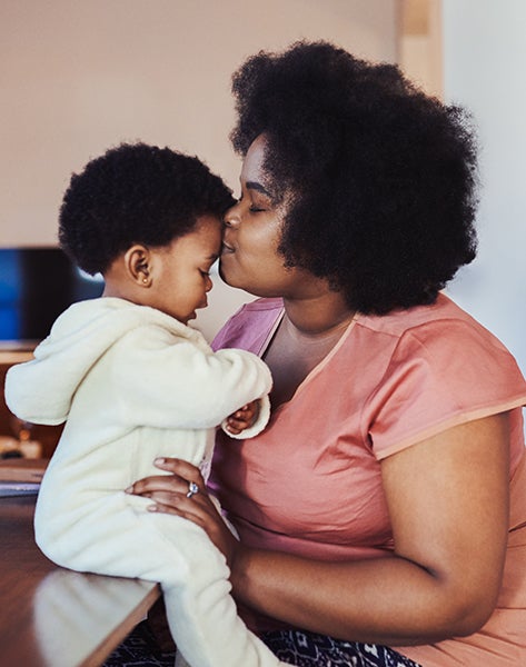 Mother and Baby Events page image - mother kisses baby on forehead