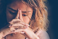 How Can You Address Increasing Demand for Behavioral Health Services? A woman with her handles folded in front of her phase who is in need of behavioral health care.