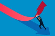 Economy May Be Down, but Digital Health Investments Boom. A man in a business suit pushes on a downward trending arrow so it no points up.