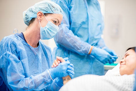 Woman and newborn in delivery room