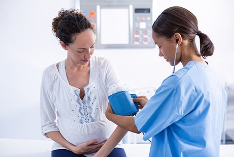 pregnant woman in medical setting getting a checkup