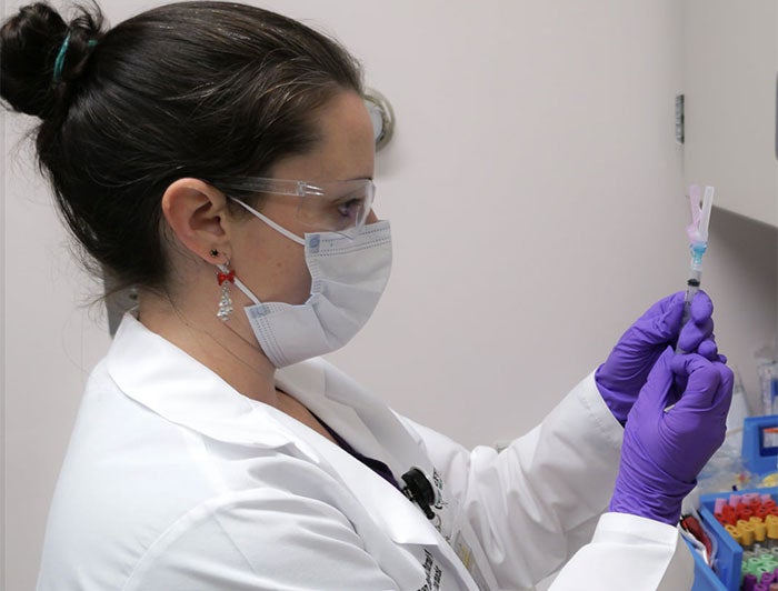 Health worker prepares an injection