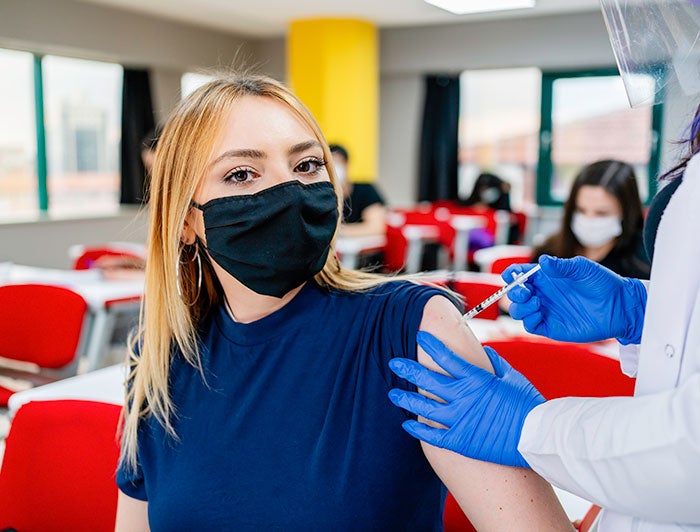 Stock photo of young woman getting a vaccination