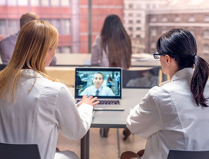 stock photo of clinical professionals wathing video on laptop