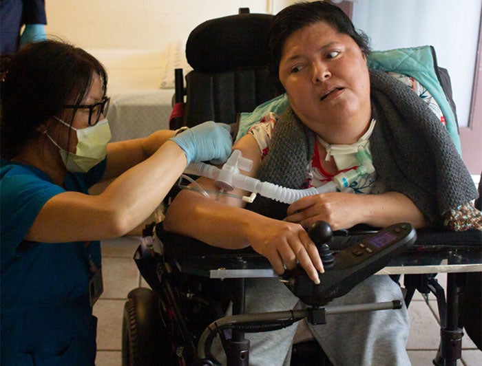 Health worker vaccinates homebound patient