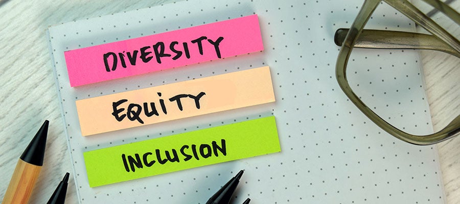 desk with small notes for diversity equity inclusion