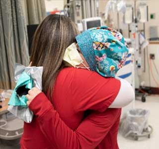 Two medical personal hugging