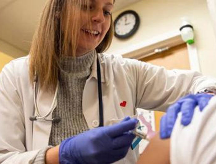 Medical personnel administering a shot