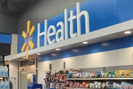 Walmart, Transcarent Team Up to Woo Self-Insured Employers. Walmart Health sign in a Walmart store.