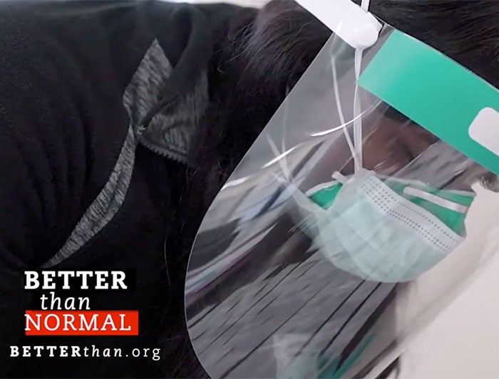 Poster image of health worker in mask and face shield looking down. text overlay: Better than Normal. betterthan.org