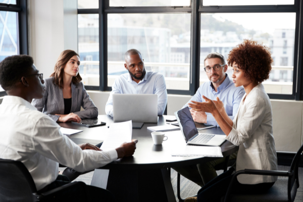 people in a meeting with computers