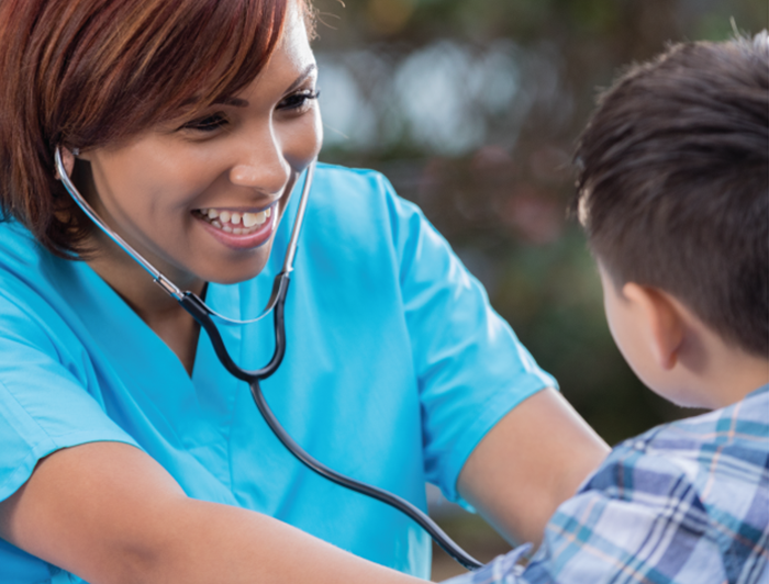 Health worker and child patient