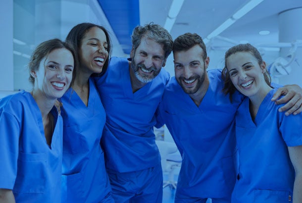 nurses with their arms around each other in support