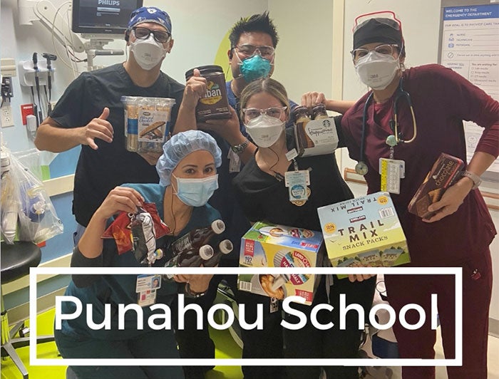 Health care workers in PPE stand with snacks. Text overlay: Punahou School