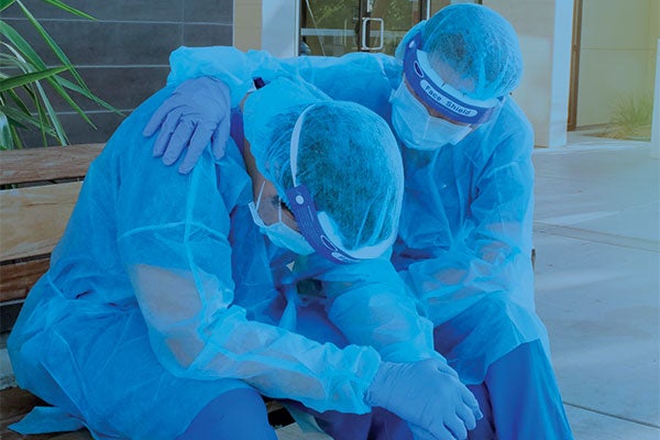 hospital worker comforting colleauge