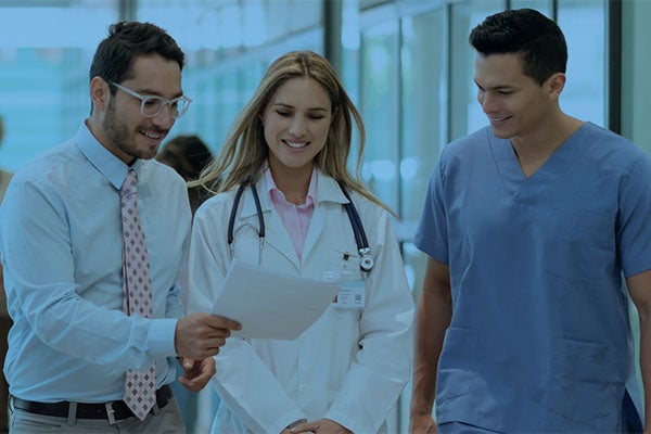 administrator doctor and nurse discuss report