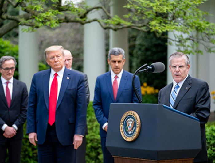 Rick Pollack stands at lectern to the right of POTUS discussing DVR