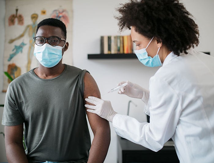 Clinician preps patient for shot