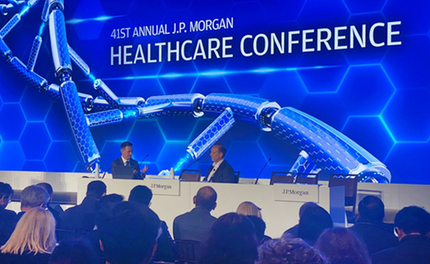 3 Looming Questions from the J.P. Morgan Health Conference. 41st Annual J.P. Morgan Healthcare Conference. Speakers on stage during a panel while an audience watches.