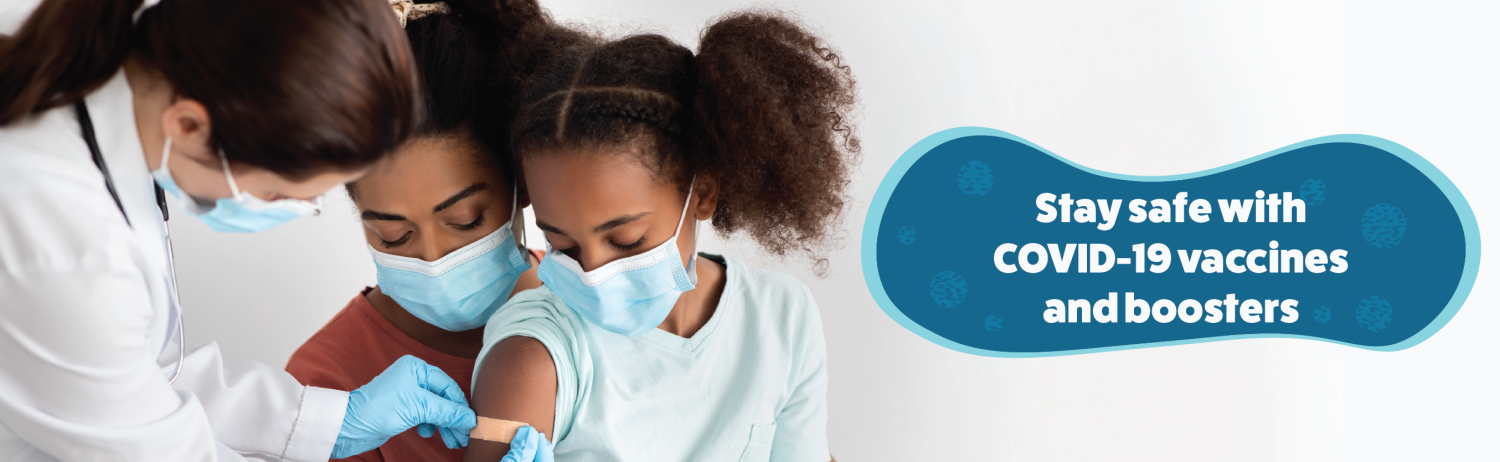 Right click to save this image of a little girl, held by her mother, receiving a bandaid on bicep from health worker. Text: Stay safe with COVID-19 vaccines and boosters