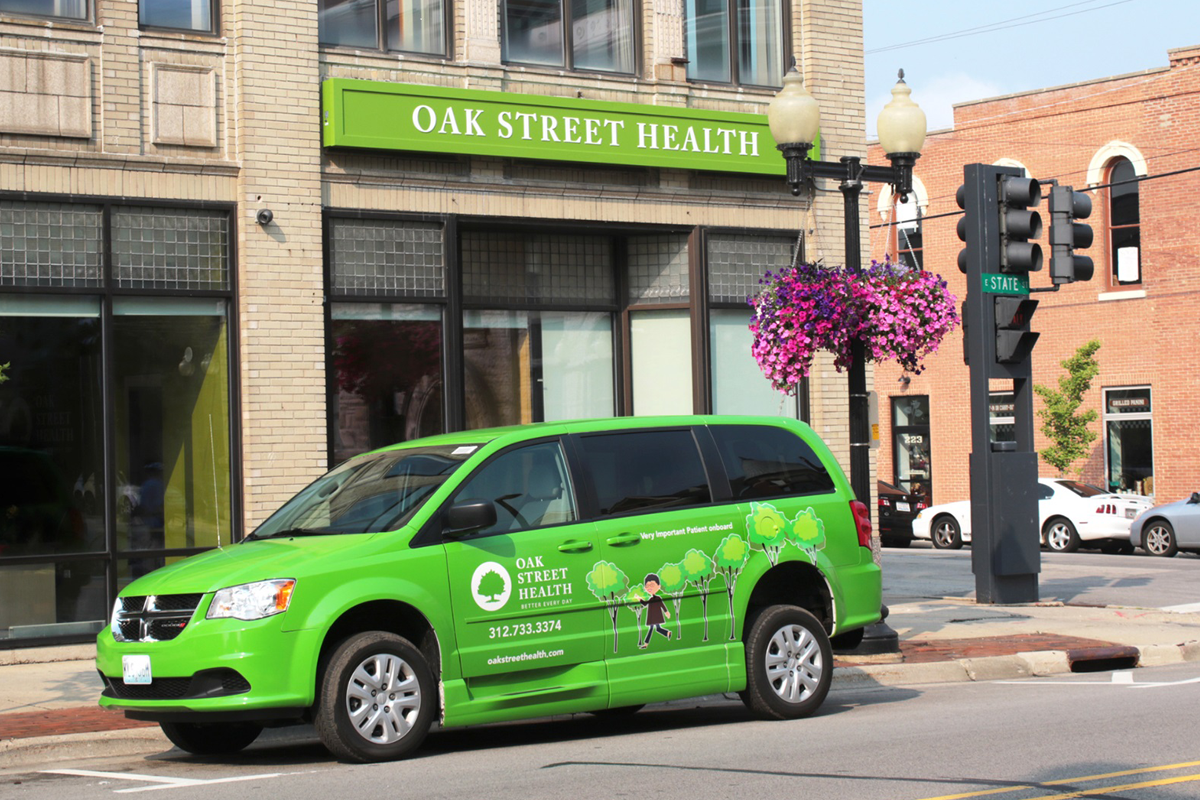 CVS Health Buys Oak Street Health, But Will the Investment Pay Off? An Oak Street Health van parked in front of a storefront with the Oak Street Health sign above it.