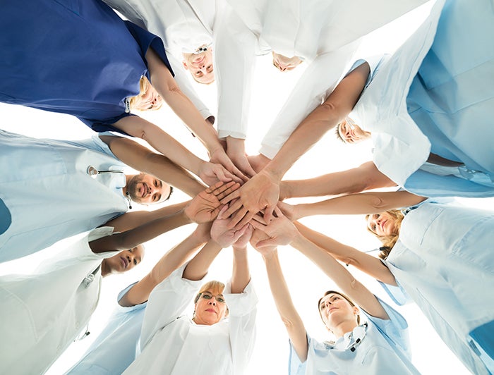 healthcare team huddle shot from below