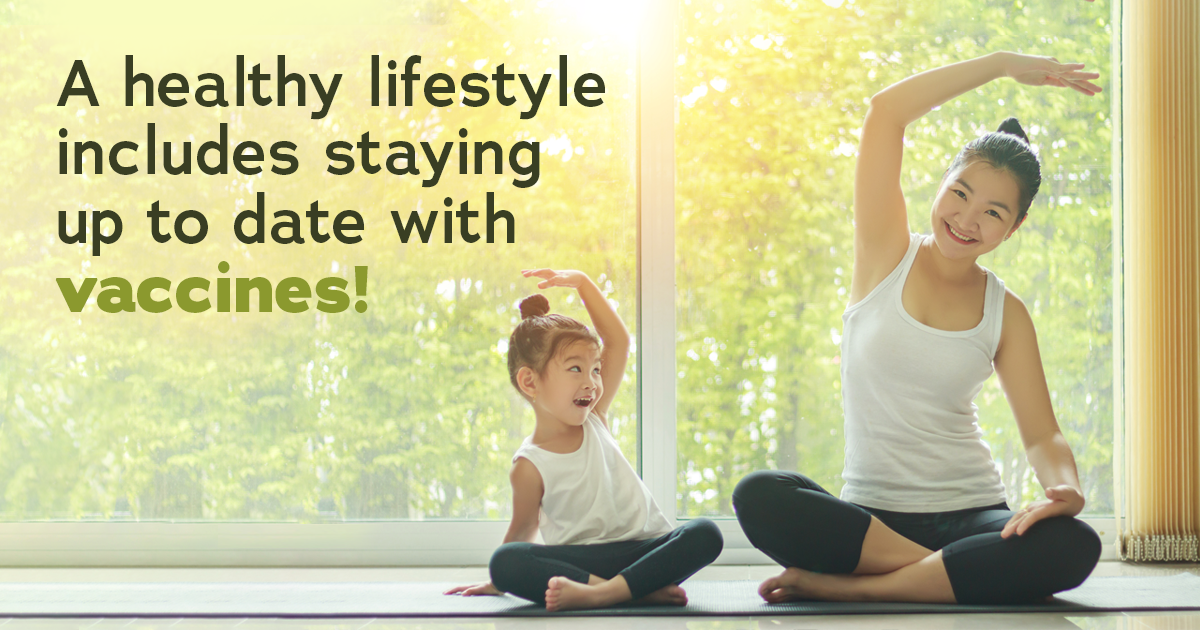 Asian mother and daughter sit on floor doing yoga stretches. Text: A healthy lifestyle includes staying up to date with vaccines