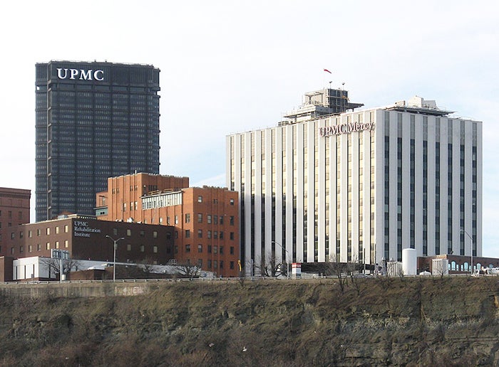 Wide shot of the UPMC Mercy campus with the UPMC tower in the background on the left