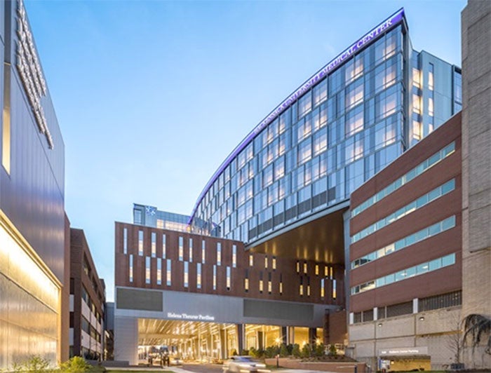 HUMC building exterior lit up at dusk