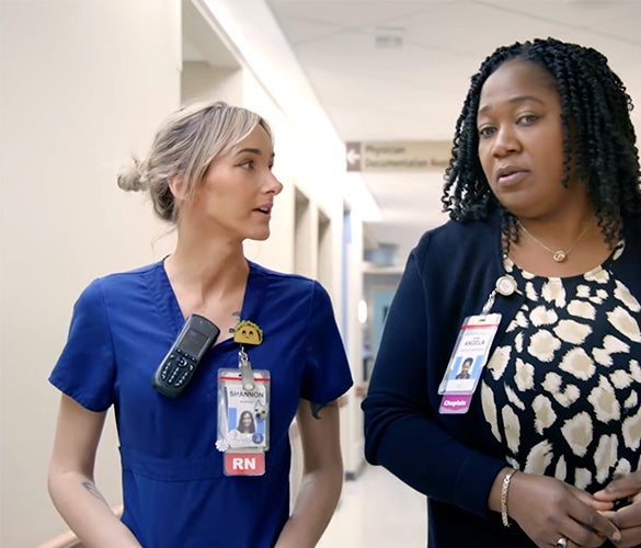 RN and Chaplain walking in hopsital hall