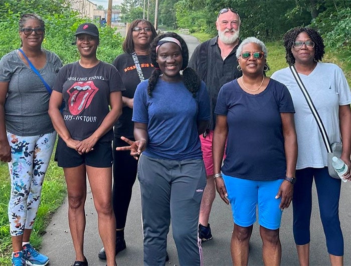 Walk With A Doc group poses on a trail