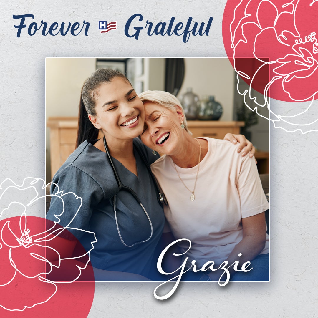 Forever Gratefule: Grazie - A female physician in scrubs smiles with an arm around an elderly patient