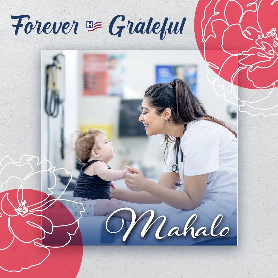 Forever Grateful: Mahalo - A female health worker sits smiling and playing with a young baby