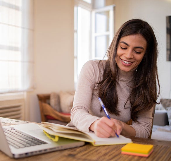 Female writing in a boook