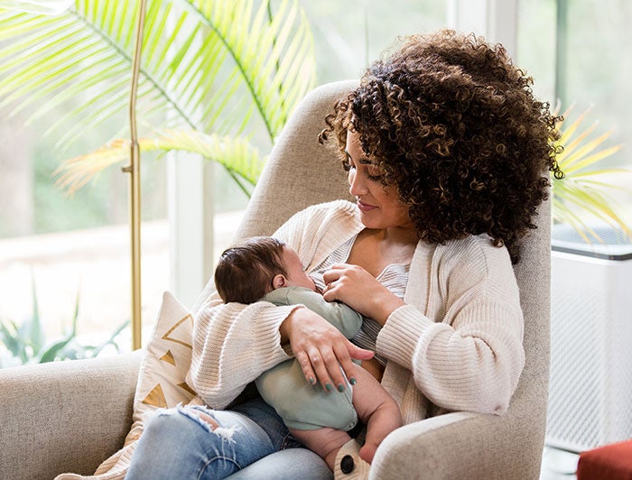 Intermountain Health. A mother sits nursing an infant.