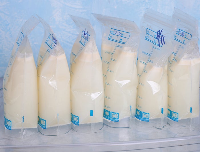 Arkansas Children's Hospital - 6 bags of expressed breast milk sit lined up on a surface.