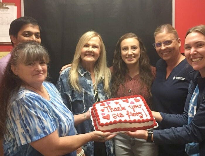 Cheyenne Regional Medical. Cindy Andrew presents staff with cake