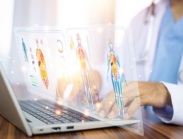 Hartford HealthCare. AI in medicine image shows a whitecoat at a laptop with a hologram of medical charts