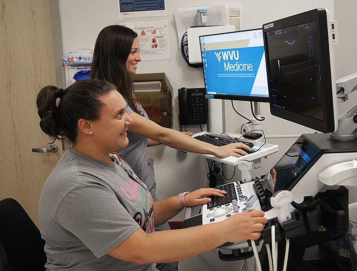 WVU Medicine. Pediatric nurse and ultrasound tech work with ceVUS